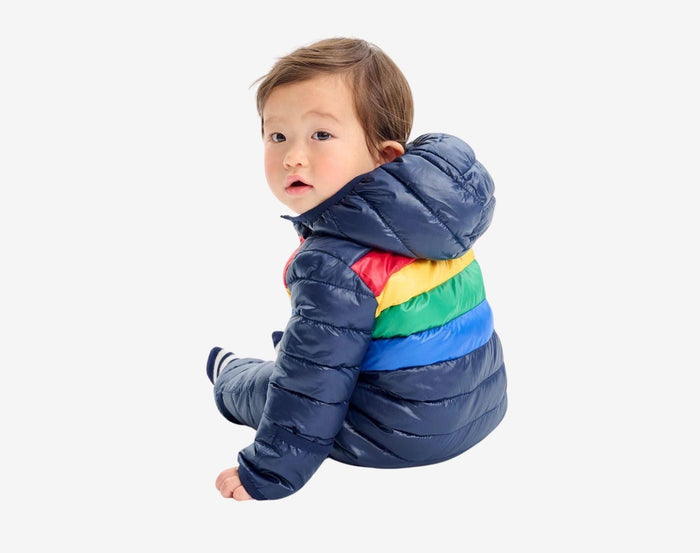 Child sitting wearing Primary - Striped Baby Lightweight Puffer Suit - Navy - Available at www.tenlittle.com
