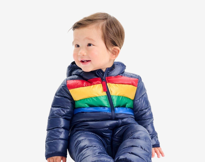 Child sitting wearing Primary - Striped Baby Lightweight Puffer Suit - Navy - Available at www.tenlittle.com