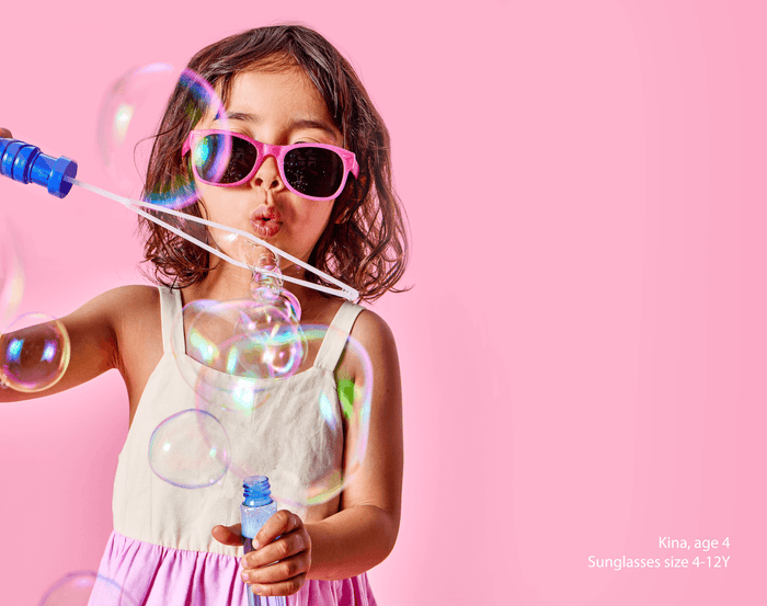 Girl age 4 playing with bubbles wearing Ten Little Sunglasses size 4-12Y - Glitter Pink. Available at www.tenlittle.com