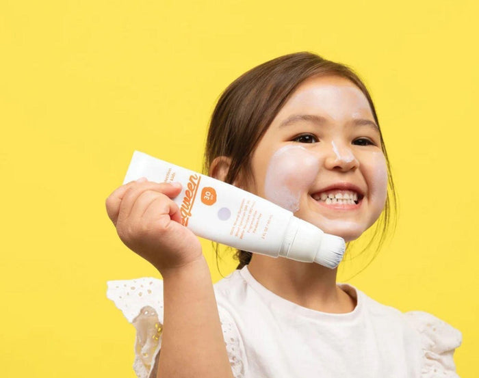 Child holding the Sqween Sunscreen Brush. Available from www.tenlittle.com