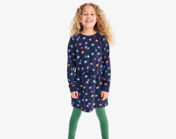 Child wearing Primary Sweatshirt Dress - Rainbow Stars - Navy / Confetti Stars. Available at www.tenlittle.com