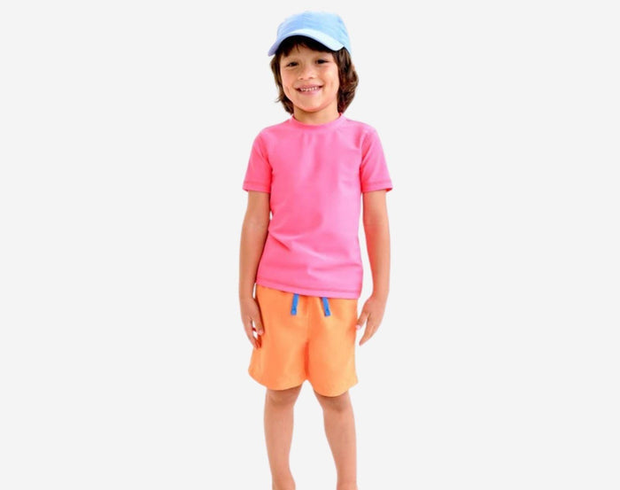 Child wearing Primary Swim Trunks in Cantaloupe - 2 Pack - Blueberry / Cantaloupe. Available at www.tenlittle.com