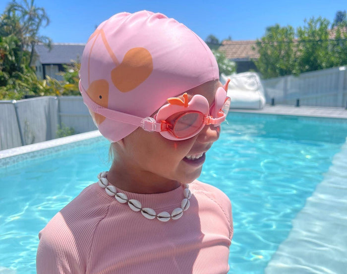Girl at pool wearing Sunnylife Swimming Cap - Cherry. Available at www.tenlittle.com