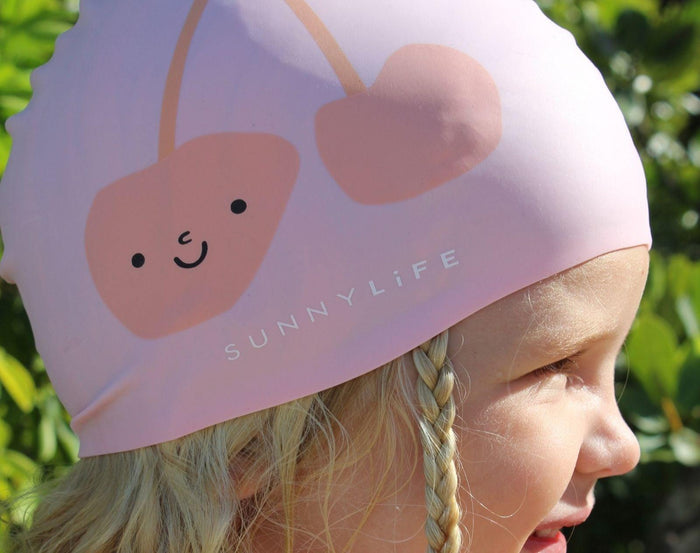 Girl wearing Sunnylife Swimming Cap - Cherry. Available at www.tenlittle.com