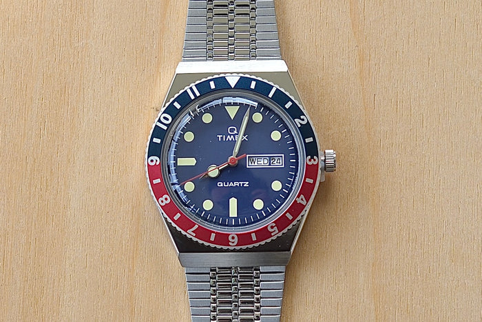 Close up of Timex Q Diver Reissue Watch Blue Face, Blue and red bezel 38mm TW2U613002V silver bracelet