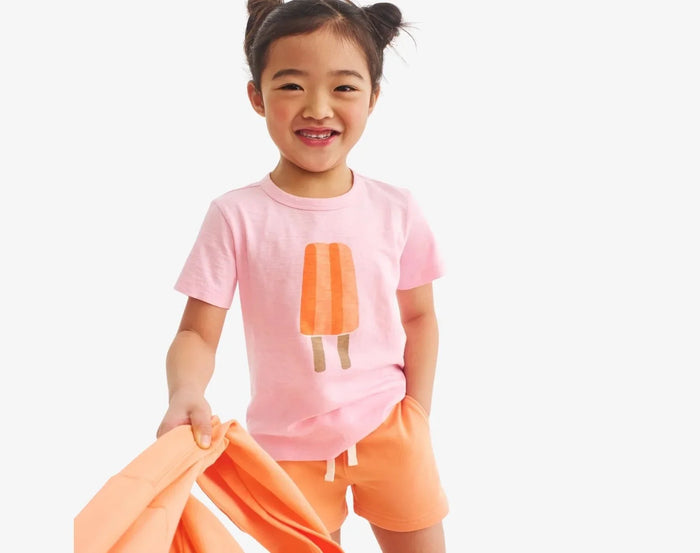Child wearing Primary Track Shorts - Goldfish. Available at www.tenlittle.com