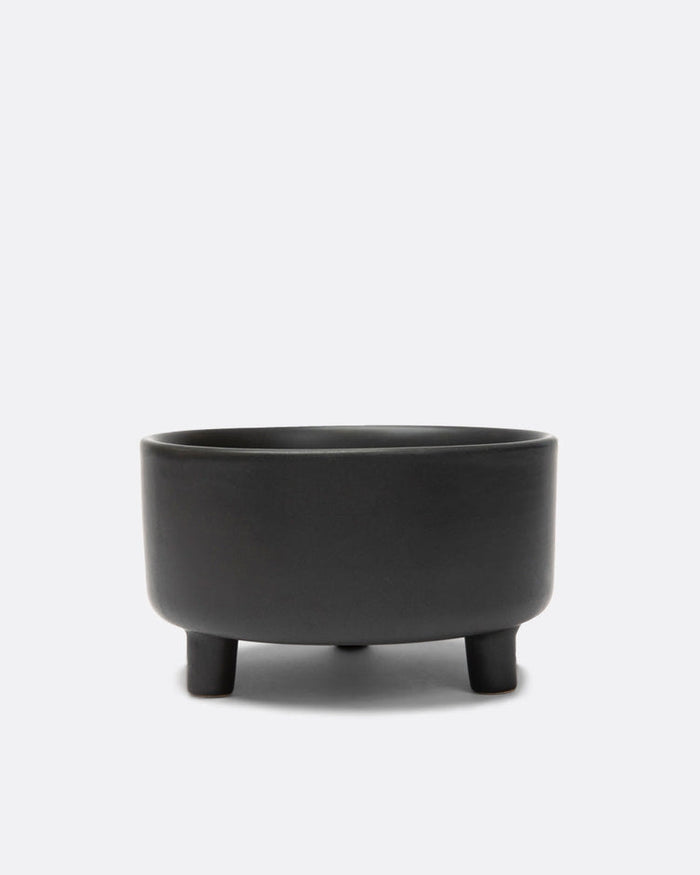 Treat Yourself Black Ceramic Dog Bowl shown with a small Pomeranian, elevated design for comfortable feeding.