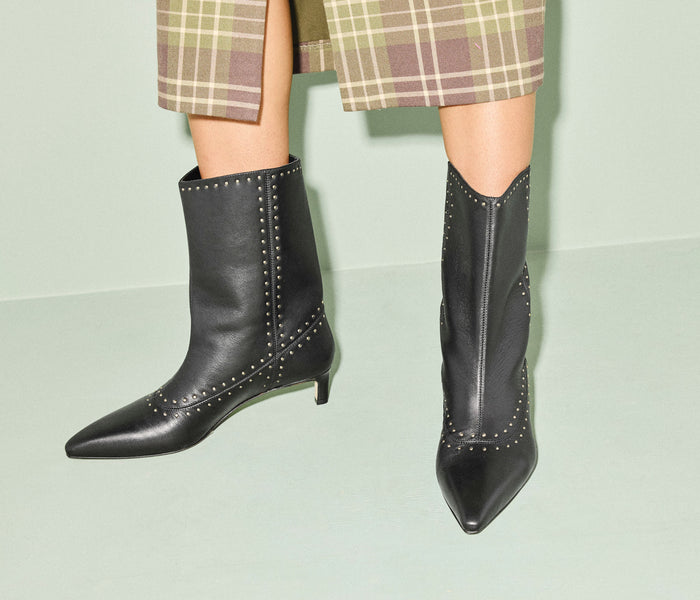 Black Tricia studded boot by FREDA SALVADOR featuring a sleek silhouette and silver stud embellishments, calf length design.