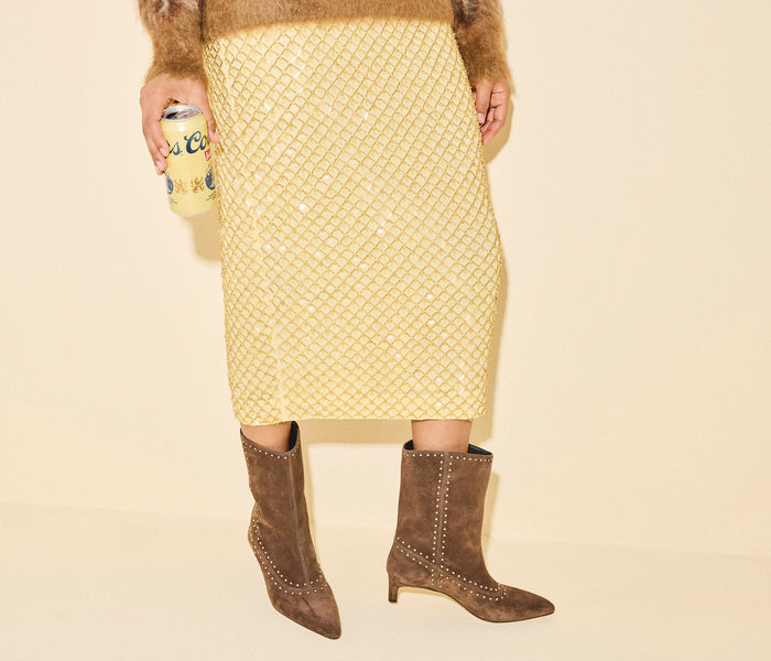 Freda Salvador Tricia studded suede boot featuring a sleek silhouette and decorative metal studs on the ankle area.