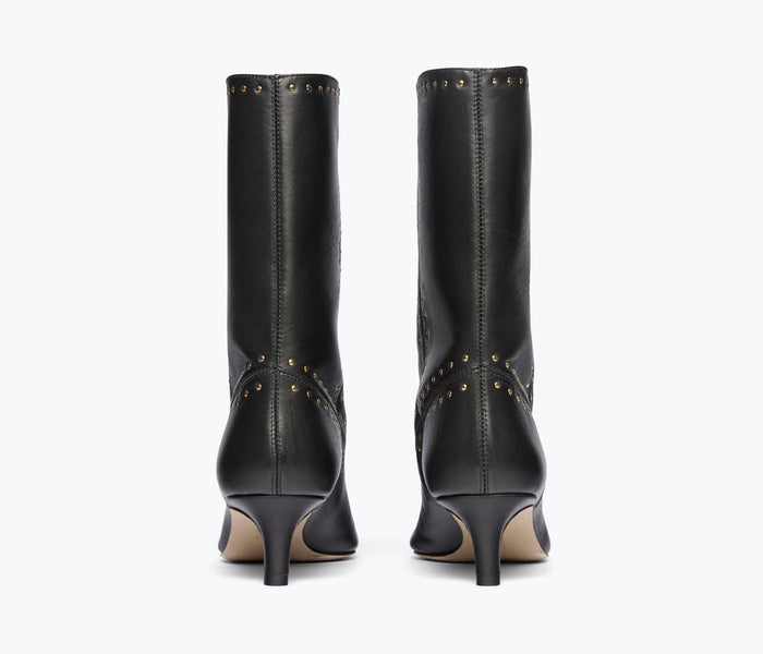 Black studded leather boot by FREDA SALVADOR, back view showing calf-length design and decorative metal studs.