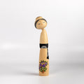 Beautiful Sosaku Kokeshi by master Sato Suigai (1920-).This one has purple flowers.