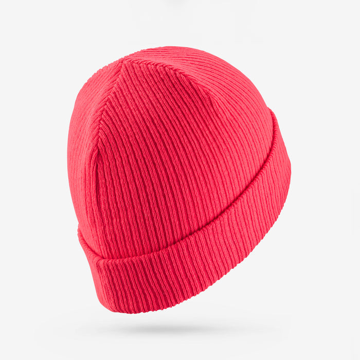 Pink knit beanie on a light gray background