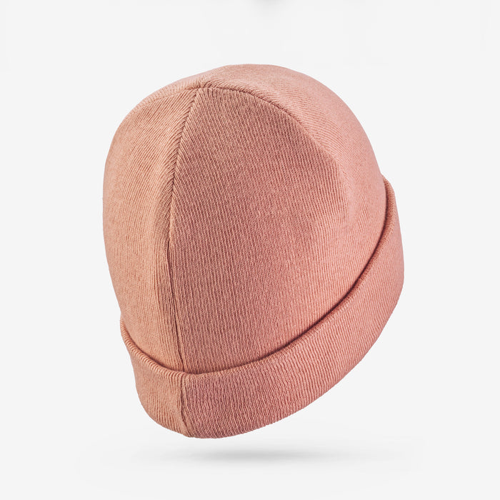 Pink beanie hat on a white background