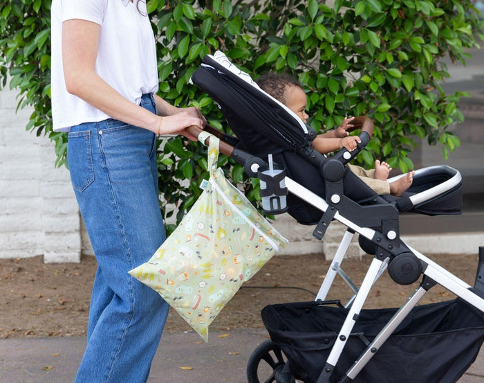 Bumkins Wet/Dry Bag - Camp Gear on stroller with woman pushing stroller with baby. Available from www.tenlittle.com